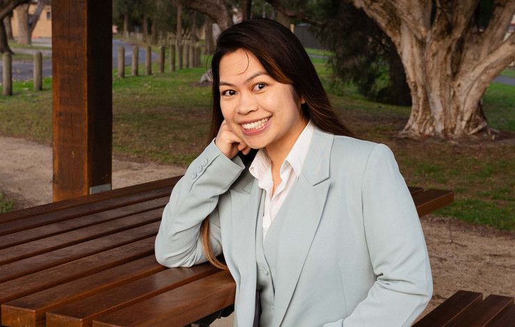 Councillor Melinda Yim sitting at a park bench