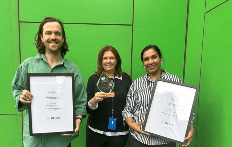 Staff members holding up the award