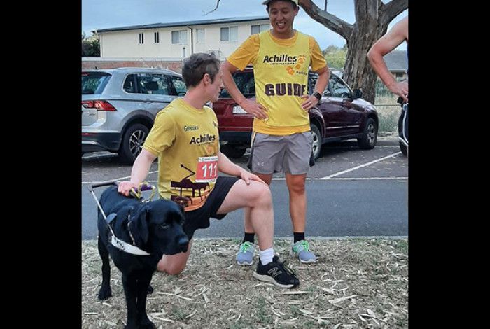 Two people with a seeing eye dog