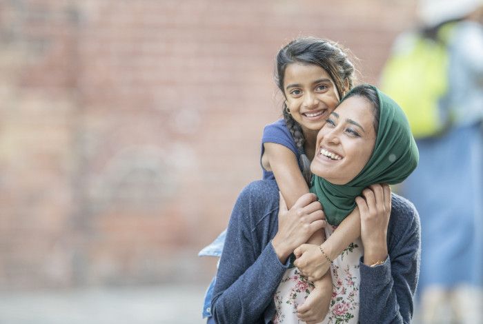 a mother and child smiling at the camera