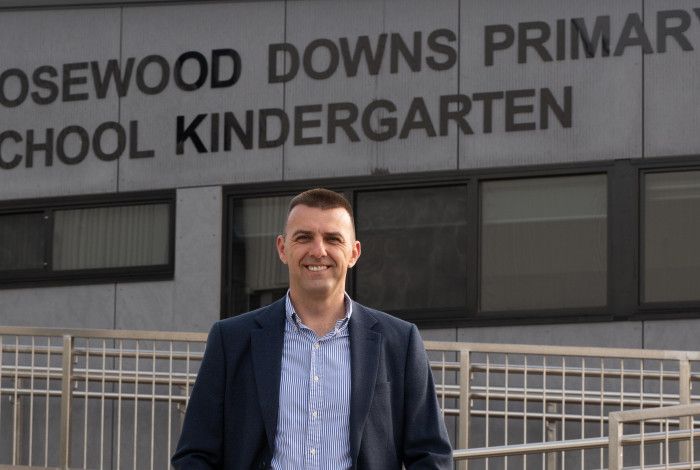 Councillor Bob Milkovic standing in front of the Rosewood Downs Primary School Kindergarten