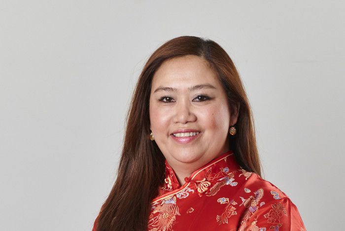 Councillor Sophie Tan in a red silk dress smiling at the camera
