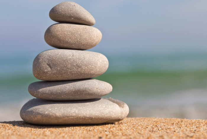 pebbles stacked on each other on a beach.