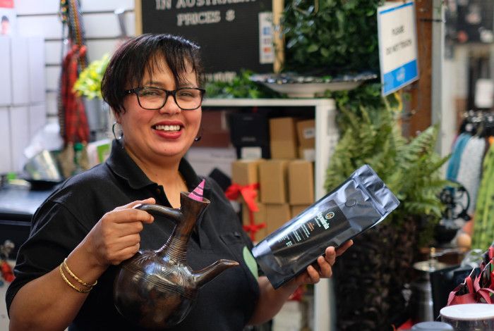 A lady holding a tea pot