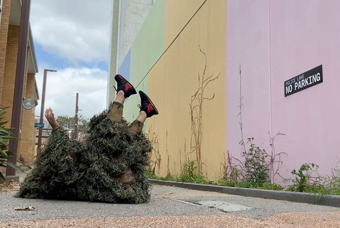 A person lying down on a footpath