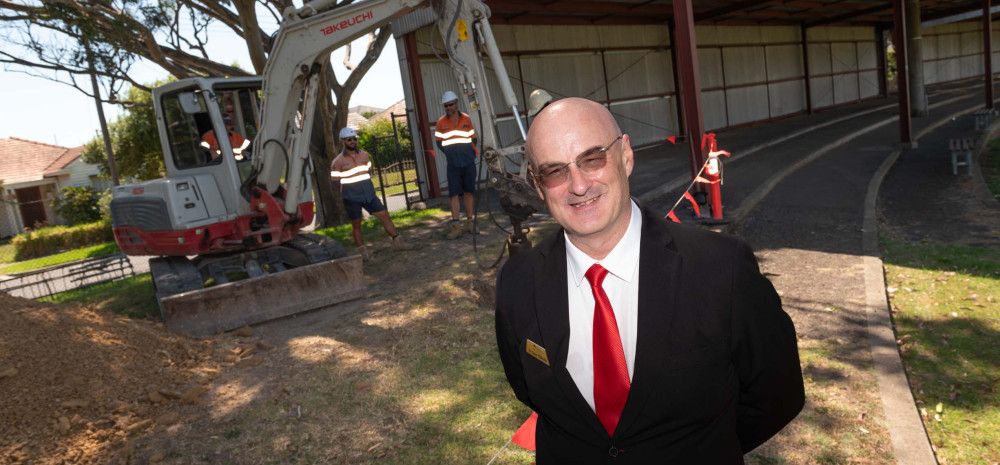 Councillor Sean O'Reilly standing in front of a work site.