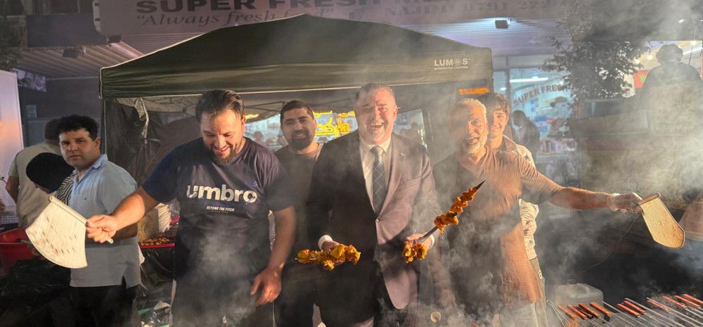 People enjoying cooking a barbecue.