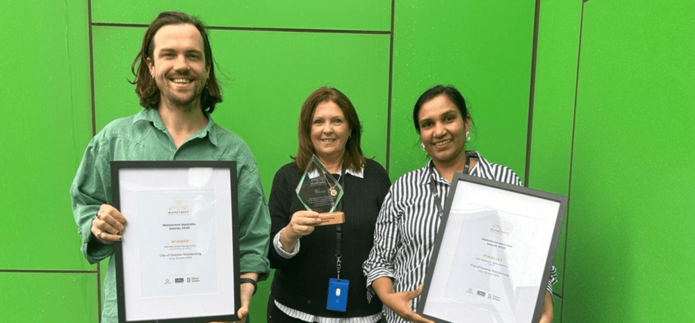 Staff members holding up the award