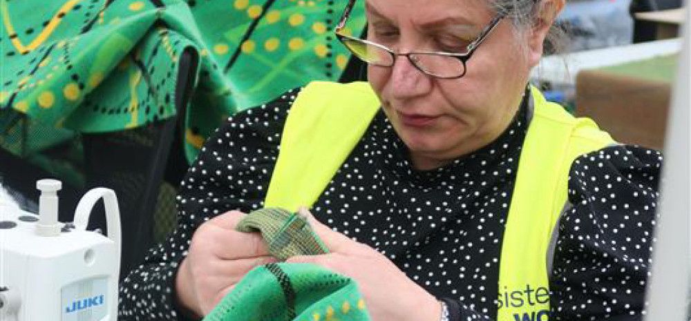 A women sewing at Sisterworks