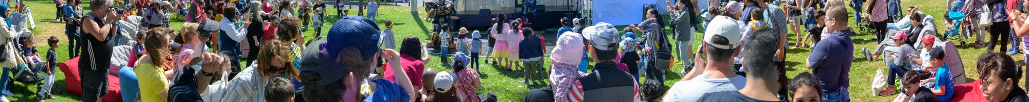A crowd of people watching a performer on the stage. 