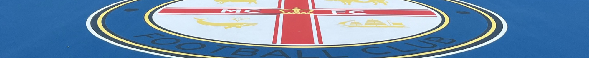 Bright blue court surface in an urban setting surrounded by high rise buildings