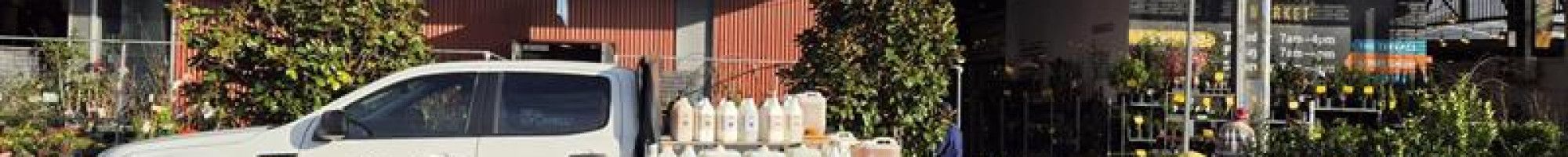 a truck parked in front of a market shed