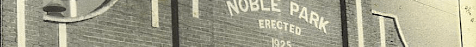 An ornate brick building with a sign reading Noble Park Public Hall erected 1825.