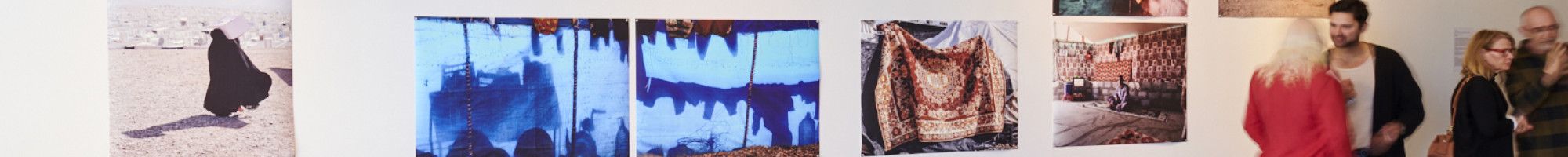 People at the HOME 25 exhibition looking at the artworks