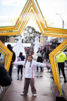 Child posing under a light-up star