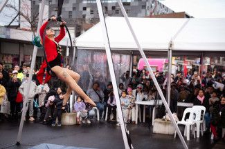 Performer hanging from an aerial hoop