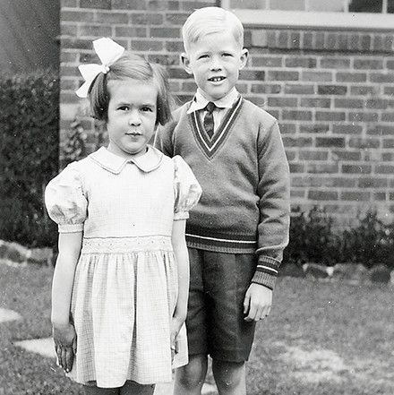 A boy and a girl standing and smiling