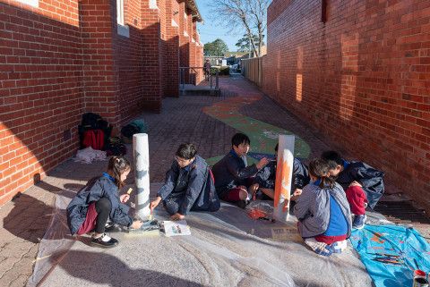 Children painting the bollards