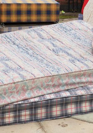 a pile of used mattresses 