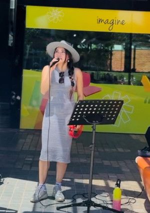 A person busking outside Dandenong Library.