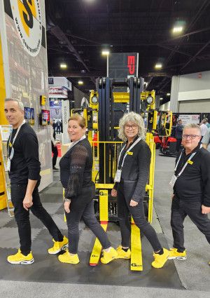 Four people smiling with equipment